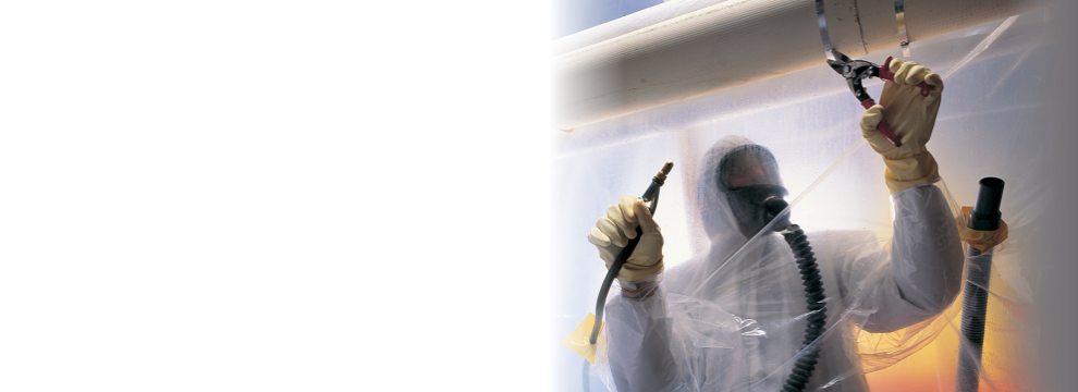 Worker in protective suit spraying ceiling