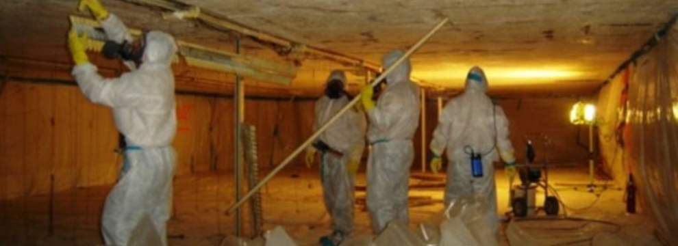 Workers in hazmat suits performing remediation